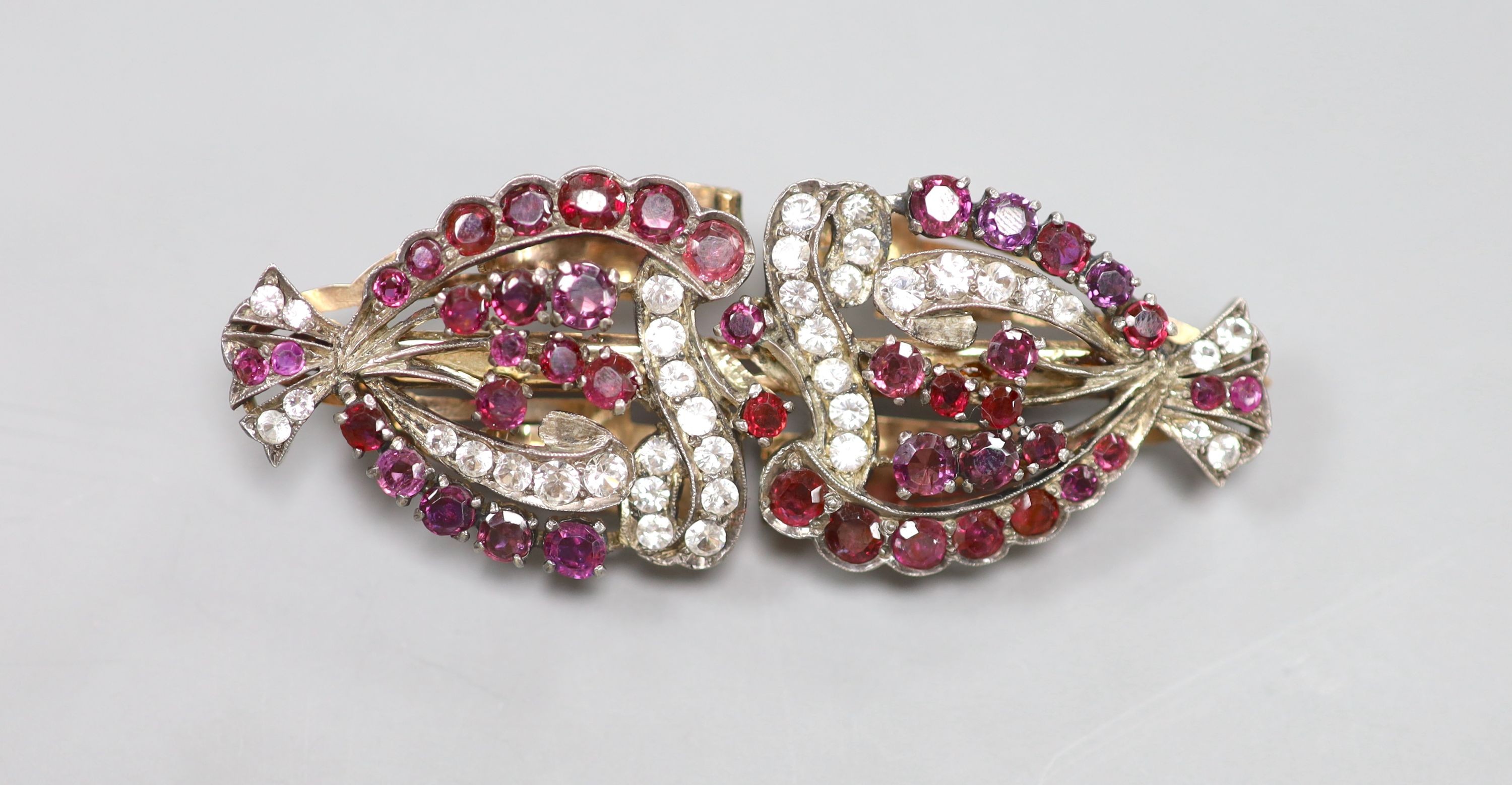 An early 20th century yellow metal and two colour paste set double clip brooch, 7cm